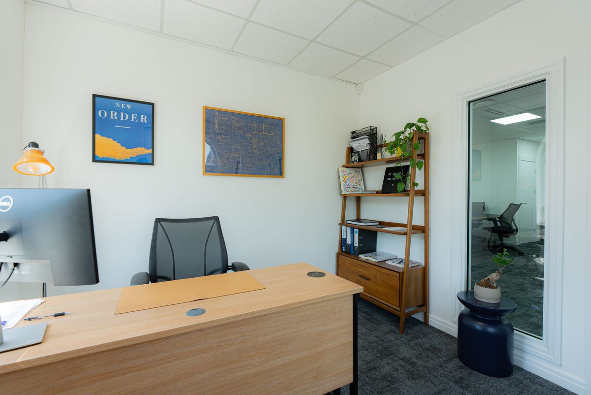 Private office fit-out with built-in shelving and glazed partition